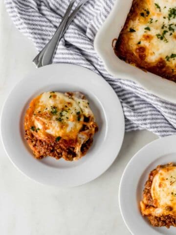 ravioli lasagna on white plates and in baking dish