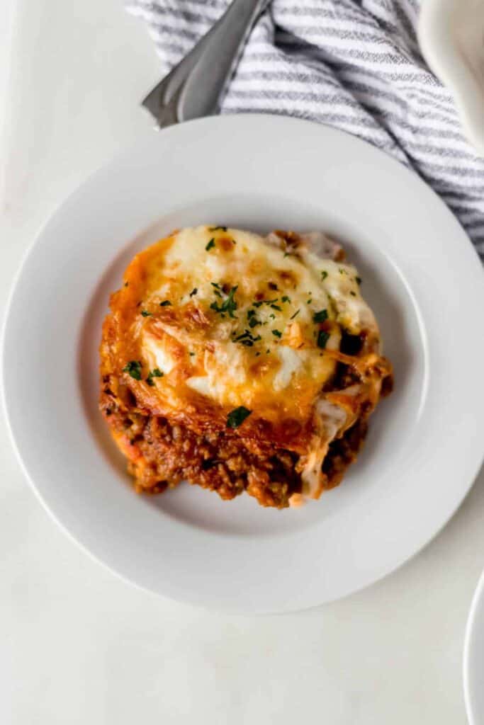 ravioli lasagna overhead shot on a white round plate