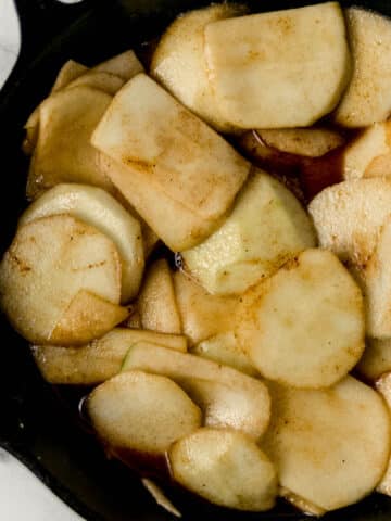 close up view of finished fried apples in cast iron skillet