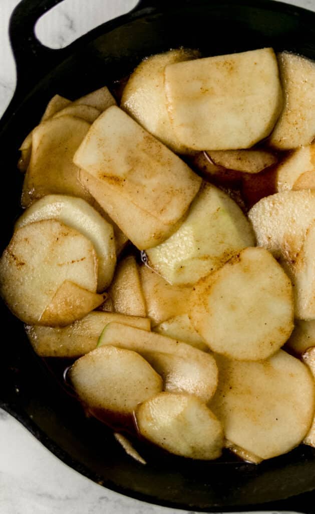 close up view of finished fried apples in cast iron skillet 