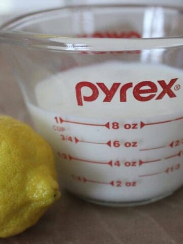 lemon and milk in measuring cup