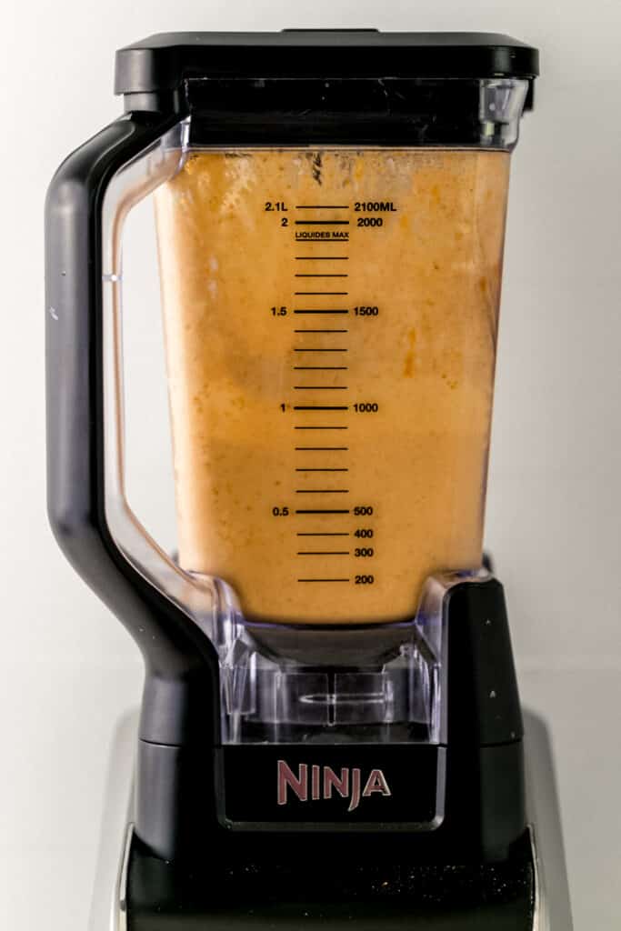 ingredients to make pumpkin spice smoothie in blender and combined together.