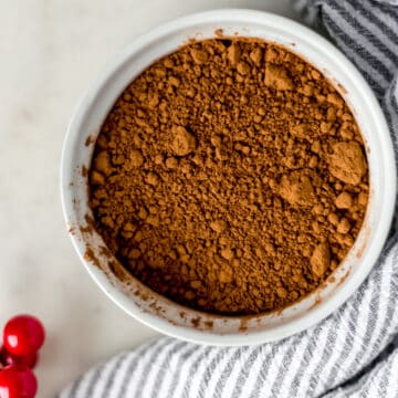 easy hot chocolate mix in a round white bowl next to a stripped cloth napkin