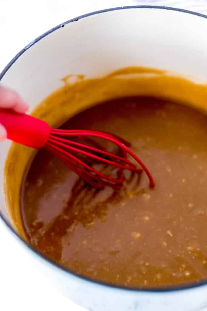 instant vanilla pudding added to wet ingredients for eggnog cookies and stirred by hand with a red whisk
