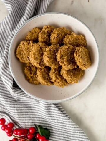 Bowl with a batch of no bake eggnog cookies over a napkin
