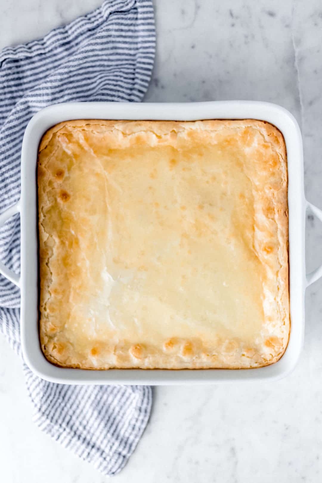 chess squares in a white baking dish with napkin