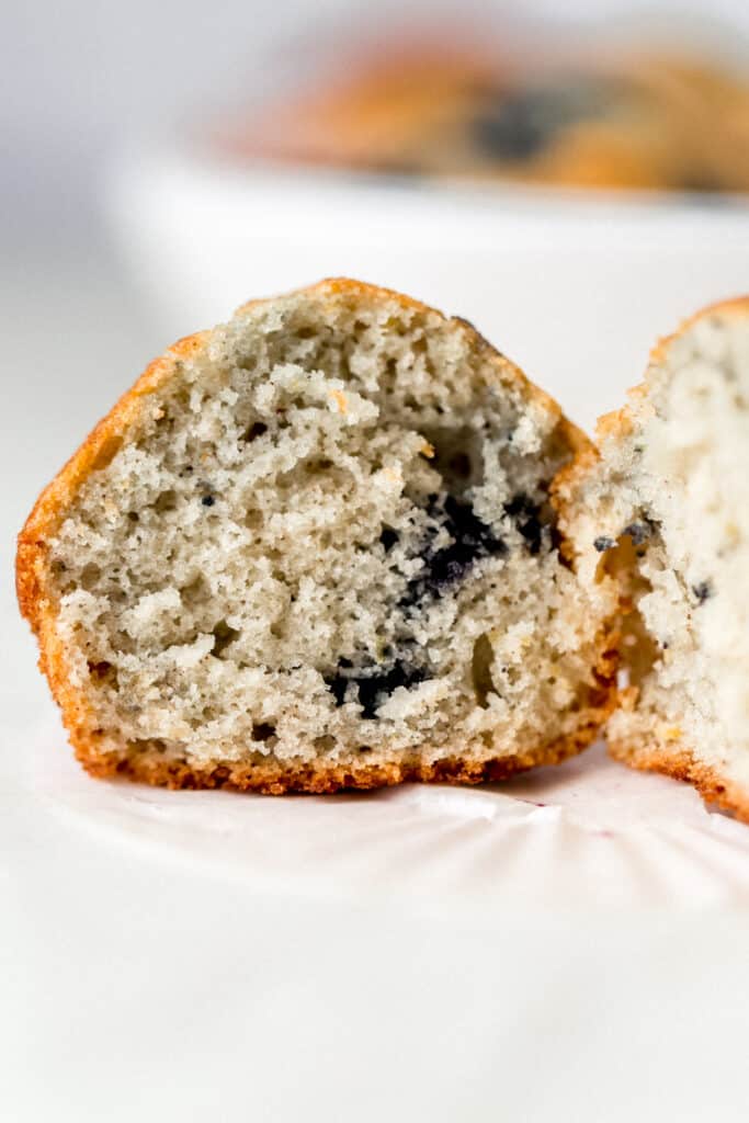side view of single blueberry muffin cut in half to show the center