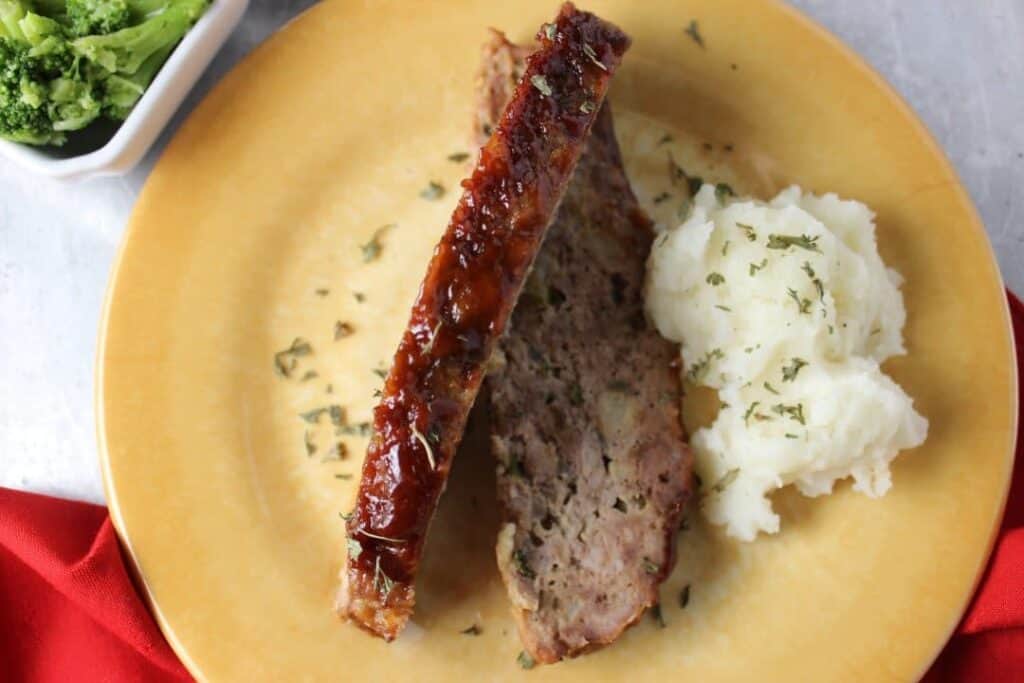 Overhead View Magical Hour Meatloaf on plate with napkin, potatoes, broccoli