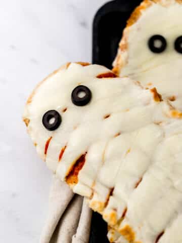 mummy pizza on top of each other on sheet pan