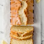 overhead view of sliced bread on parchment paper with lemon slices