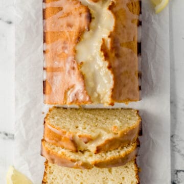 overhead view of sliced bread on parchment paper with lemon slices