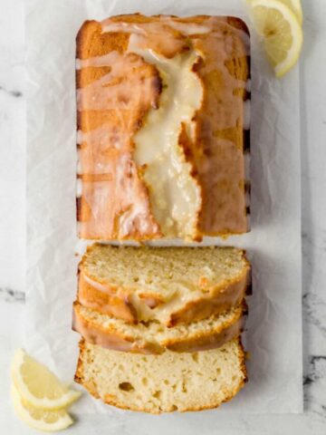 overhead view of sliced bread on parchment paper with lemon slices