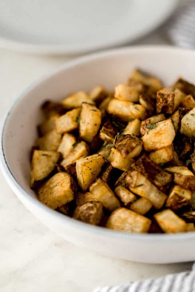 side view easy roasted potatoes in serving bowl 