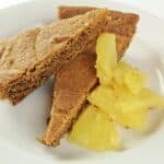 pieces of cookie on white plate with pineapple