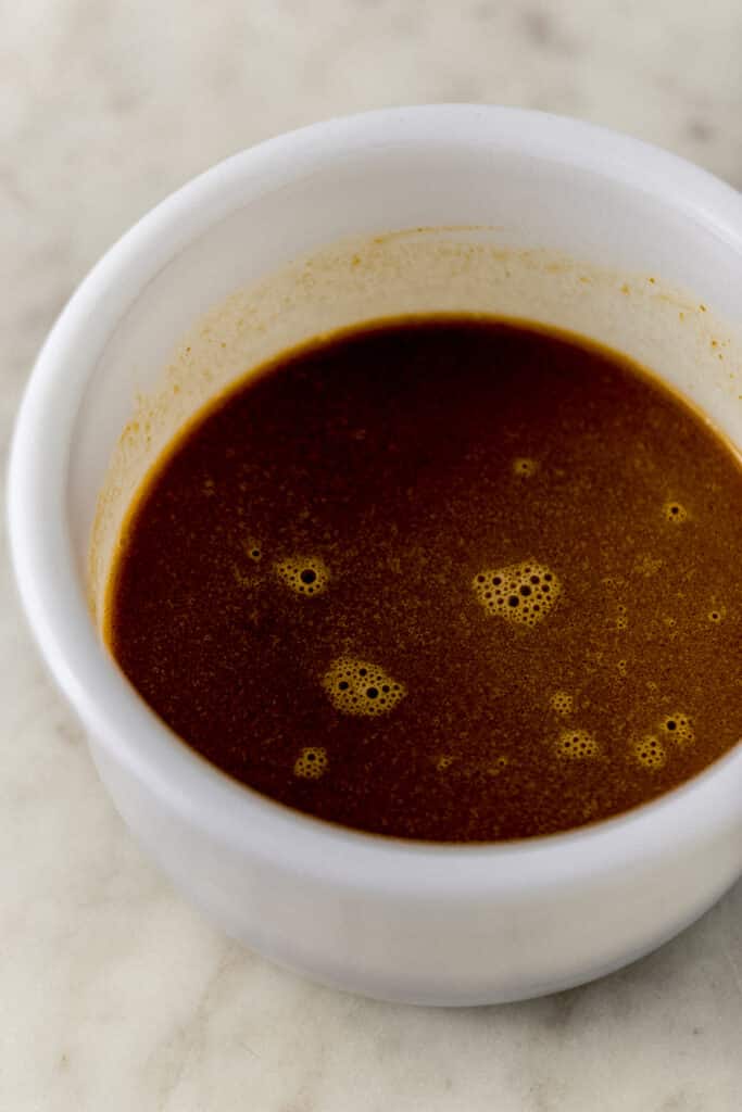 wet ingredient to make pumpkin spice latte waffles combined in white mixing bowl 
