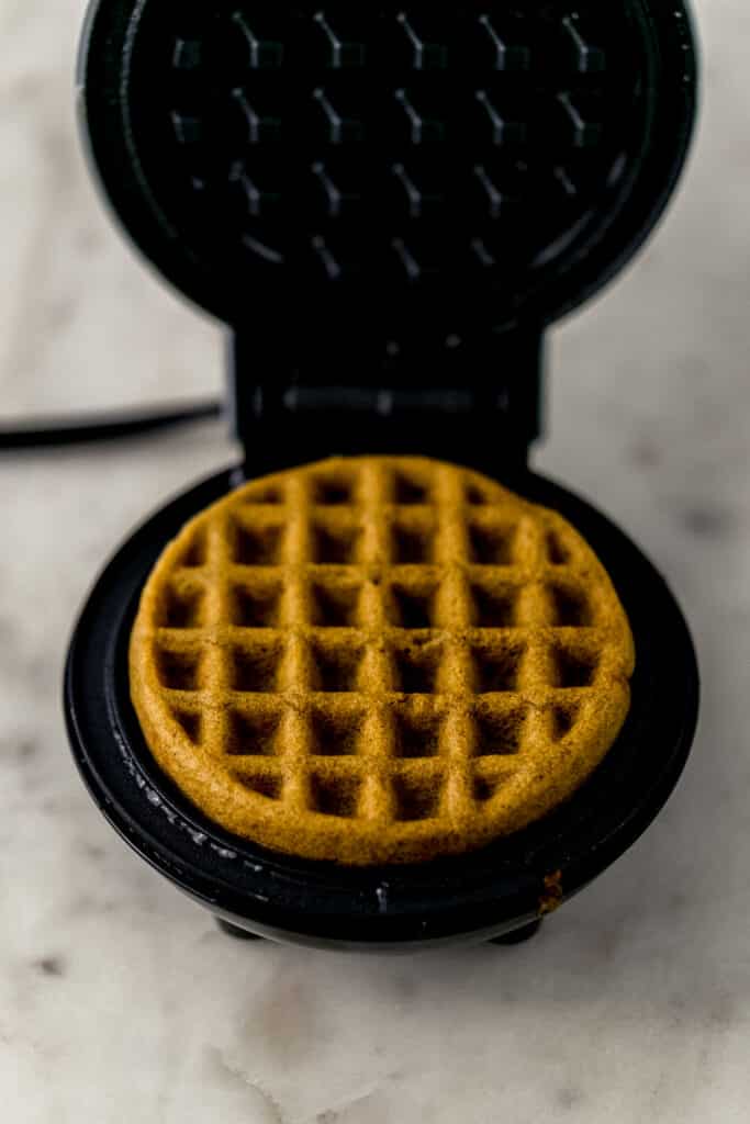 waffle maker with finished waffle in it. 