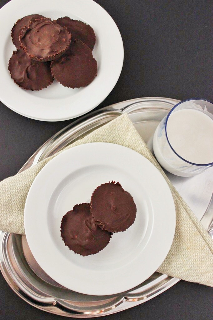 overhead view of vegan peanut butter cups on plate with a glass of milk