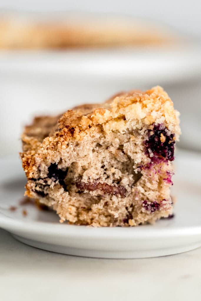 piece of blueberry coffee cake on small white plate