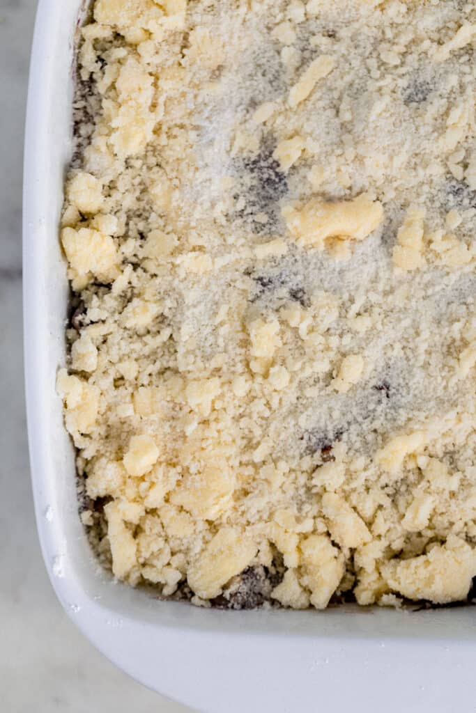 streusel topping spread evenly on top of coffee cake mixture in baking dish