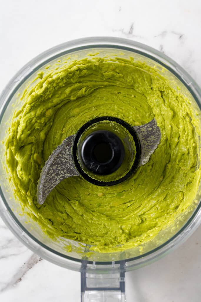 overhead view of puree avocado in food processor 