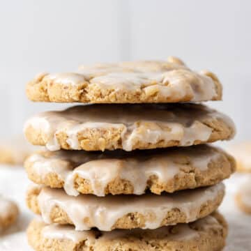close up side view stack of iced oatmeal cookies