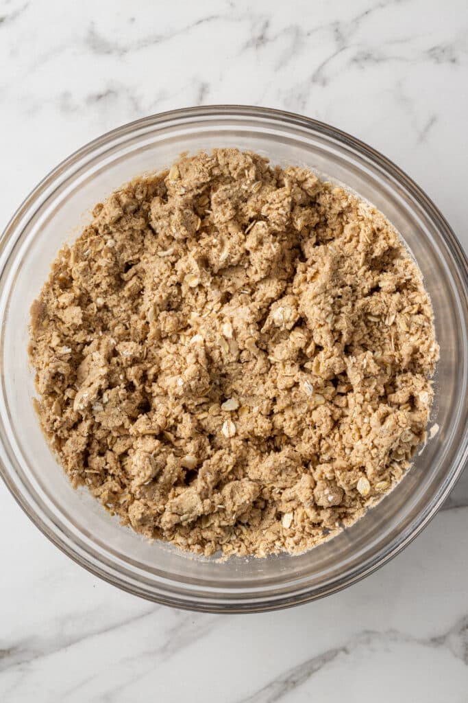 overhead view of cookie mixture in glass mixing bowl