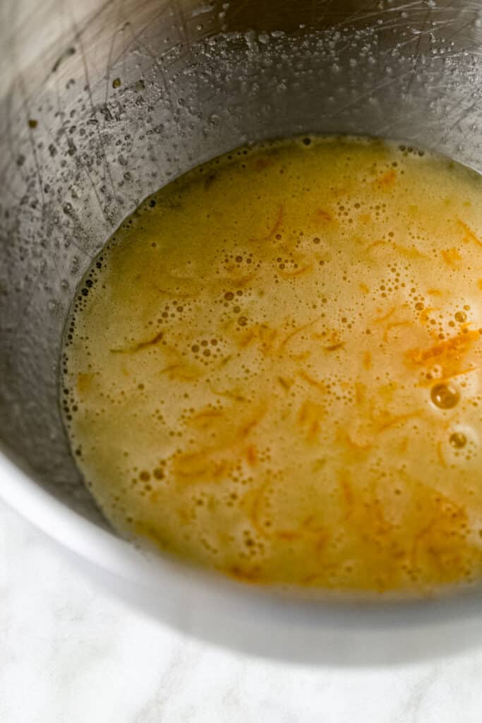 wet ingredients for orange olive oil cake in metal mixing bowl 