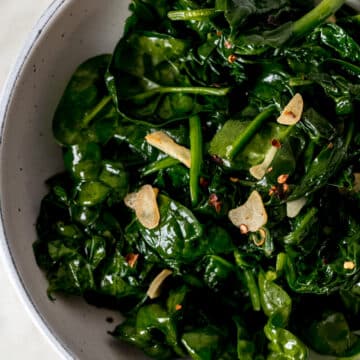 overhead view of sauteed garlic spinach in a large bowl