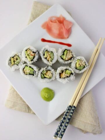 sushi on white plate with chop sticks