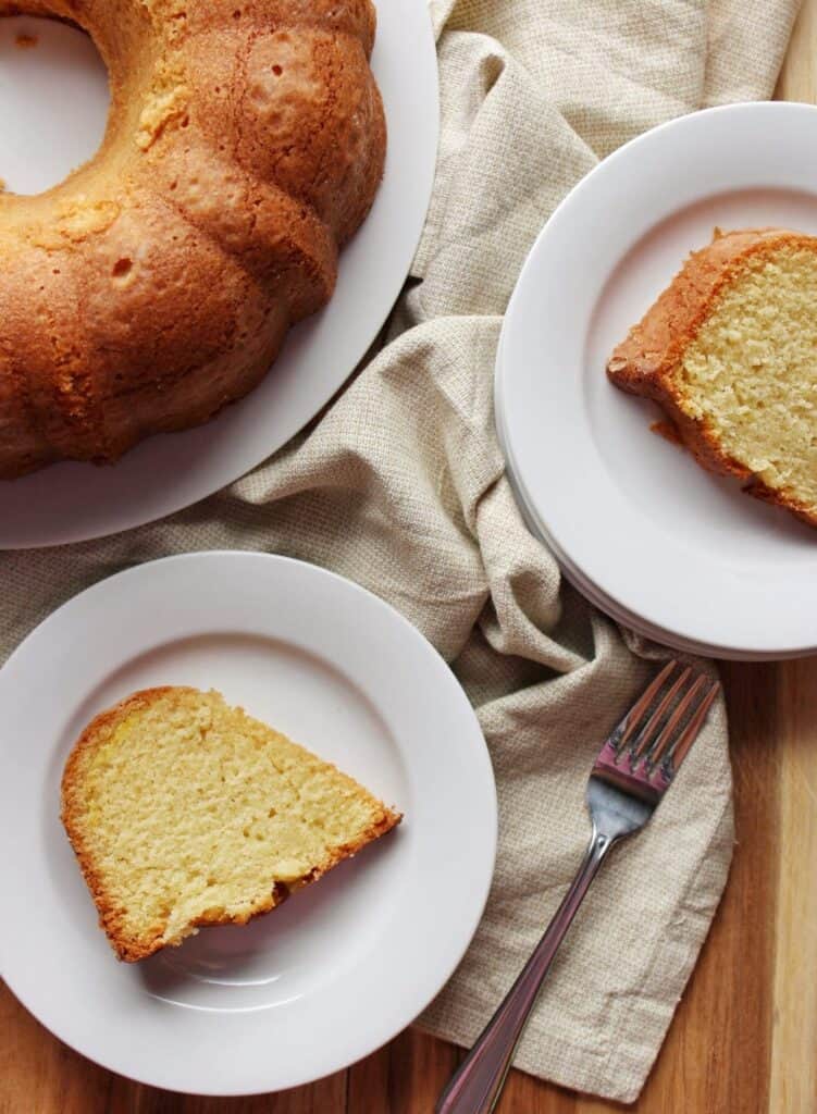 overhead view of cake with slices on two white plates 