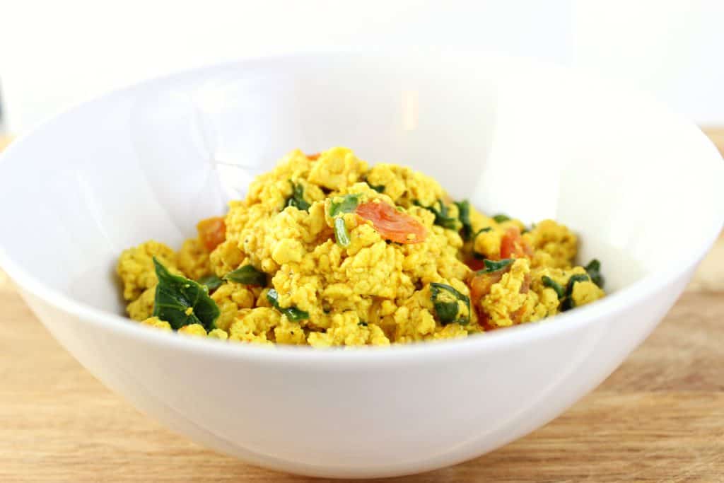 Tofu Scramble - Simply recipe made with baby spinach, diced tomatoes, and sauteed onions. Very quick and easy to make in under 30 minutes. simplylakita.com #vegan #tofu