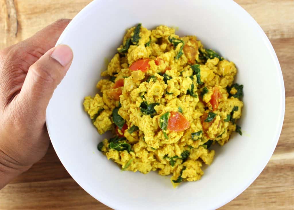 Tofu Scramble - Simply recipe made with baby spinach, diced tomatoes, and sauteed onions. Very quick and easy to make in under 30 minutes. simplylakita.com #vegan #tofu