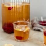 iced green tea in pitcher and two glasses with lemon slices and cloth napkin