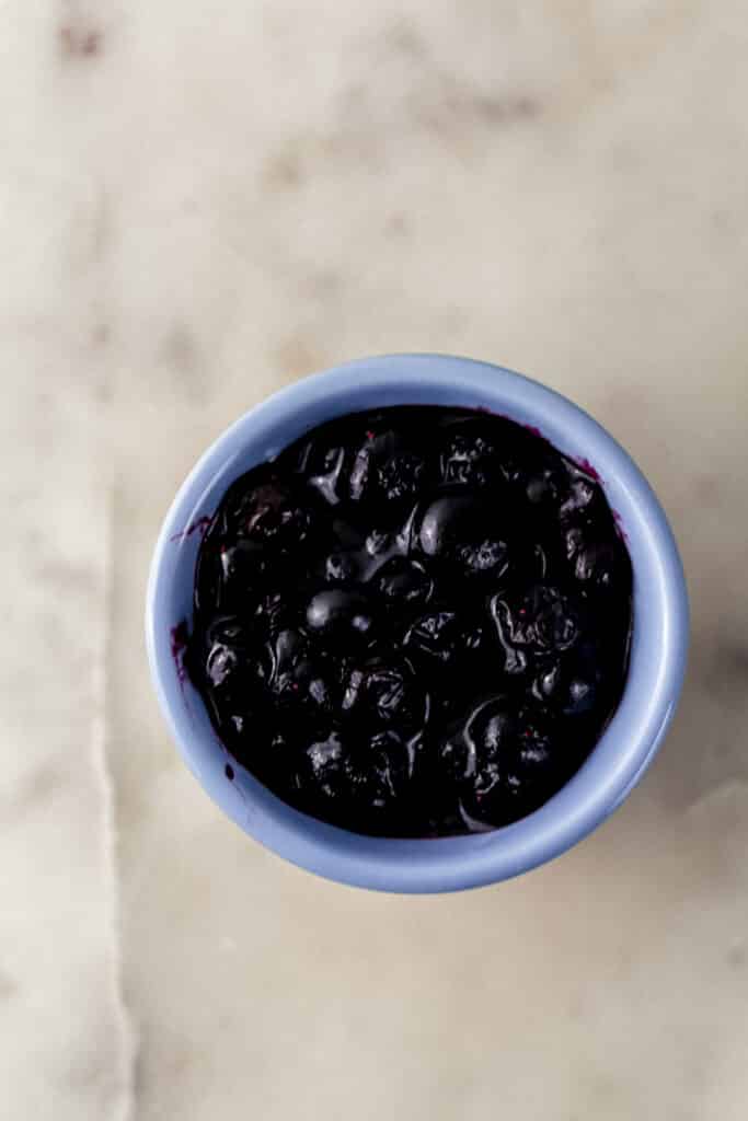 cooked fresh blueberries in small blue bowl 