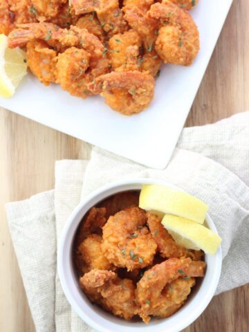 overhead view of Buffalo Shrimp in bowl and on plate with napkin