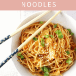 spicy kimchi sesame noodles in a bowl with chop sticks