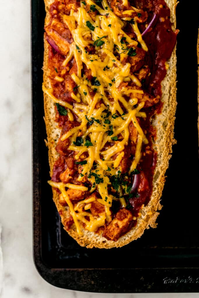 BBQ French bread pizza on baking sheet after baking and before serving. 