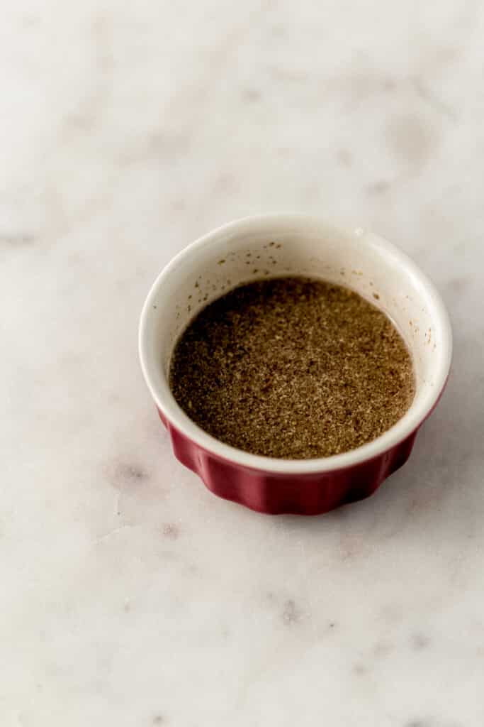 small red bowl with ground flax meal and water combined in it.