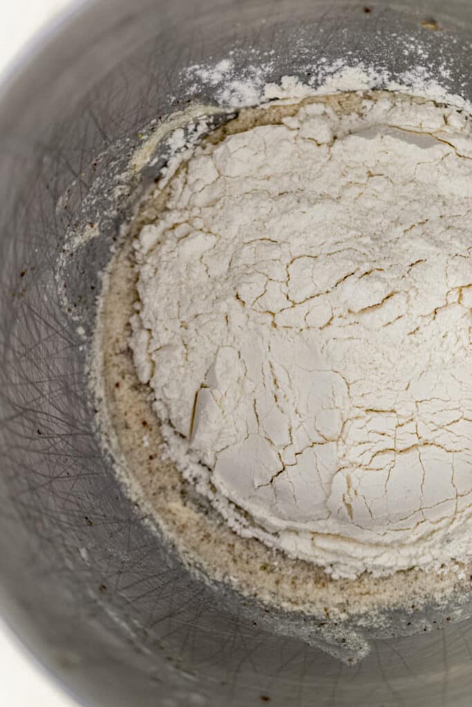 flour mixture added to cupcake mixture in mixing bowl