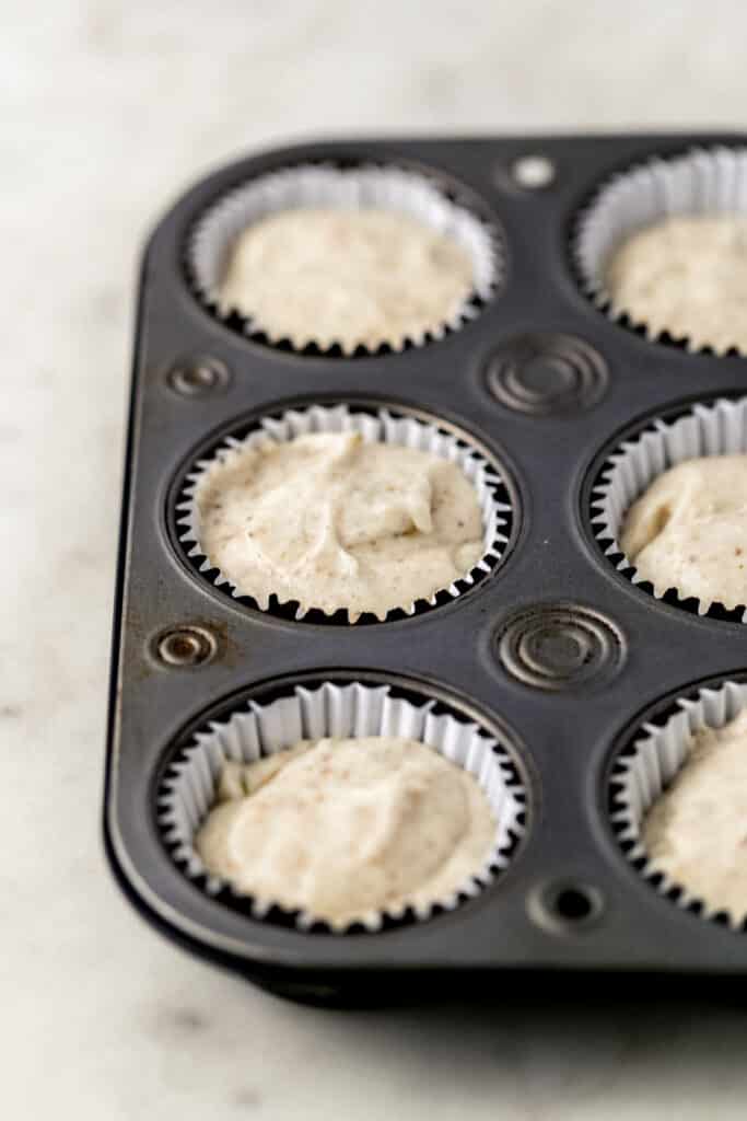 cupcake mixture added into muffin pan with liners. 