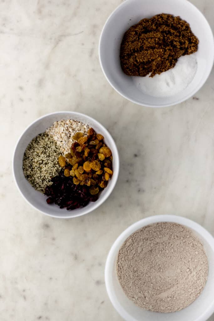 overhead view ingredients to make harvest cookies in separate white bowls