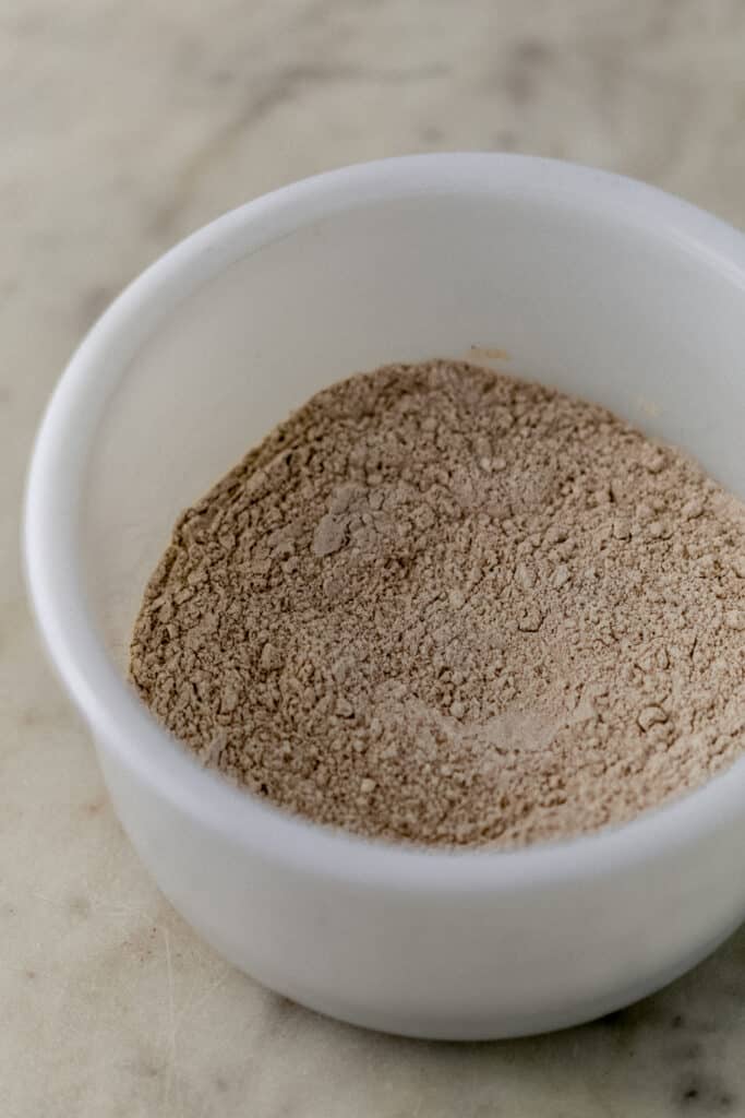 white mixing bowl with dry ingredients mixed together for cookie recipe. 