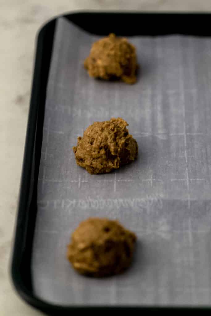 unbaked cookies on parchment lined baking sheet 