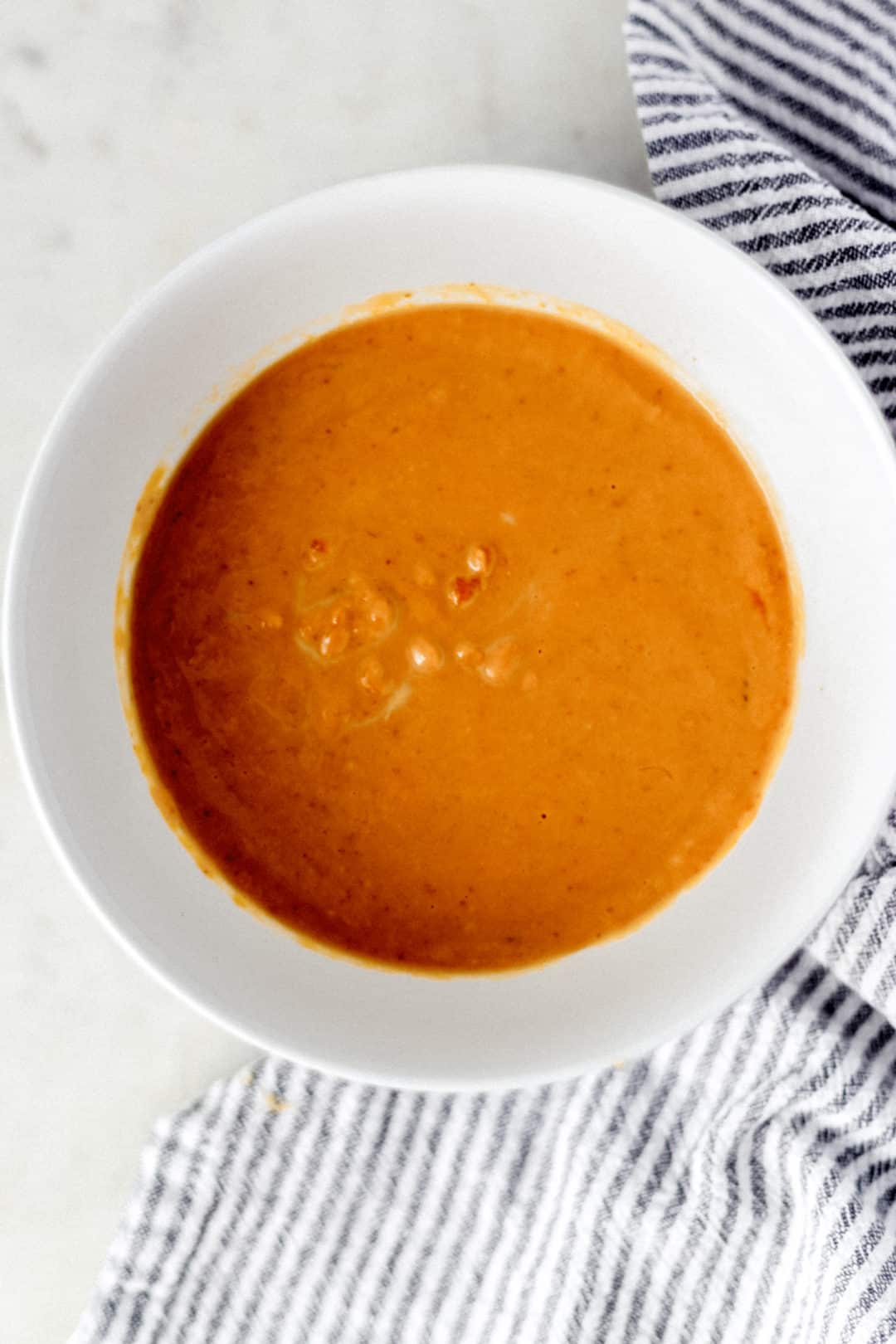 small white bowl with pumpkin puree mixture for pumpkin scones