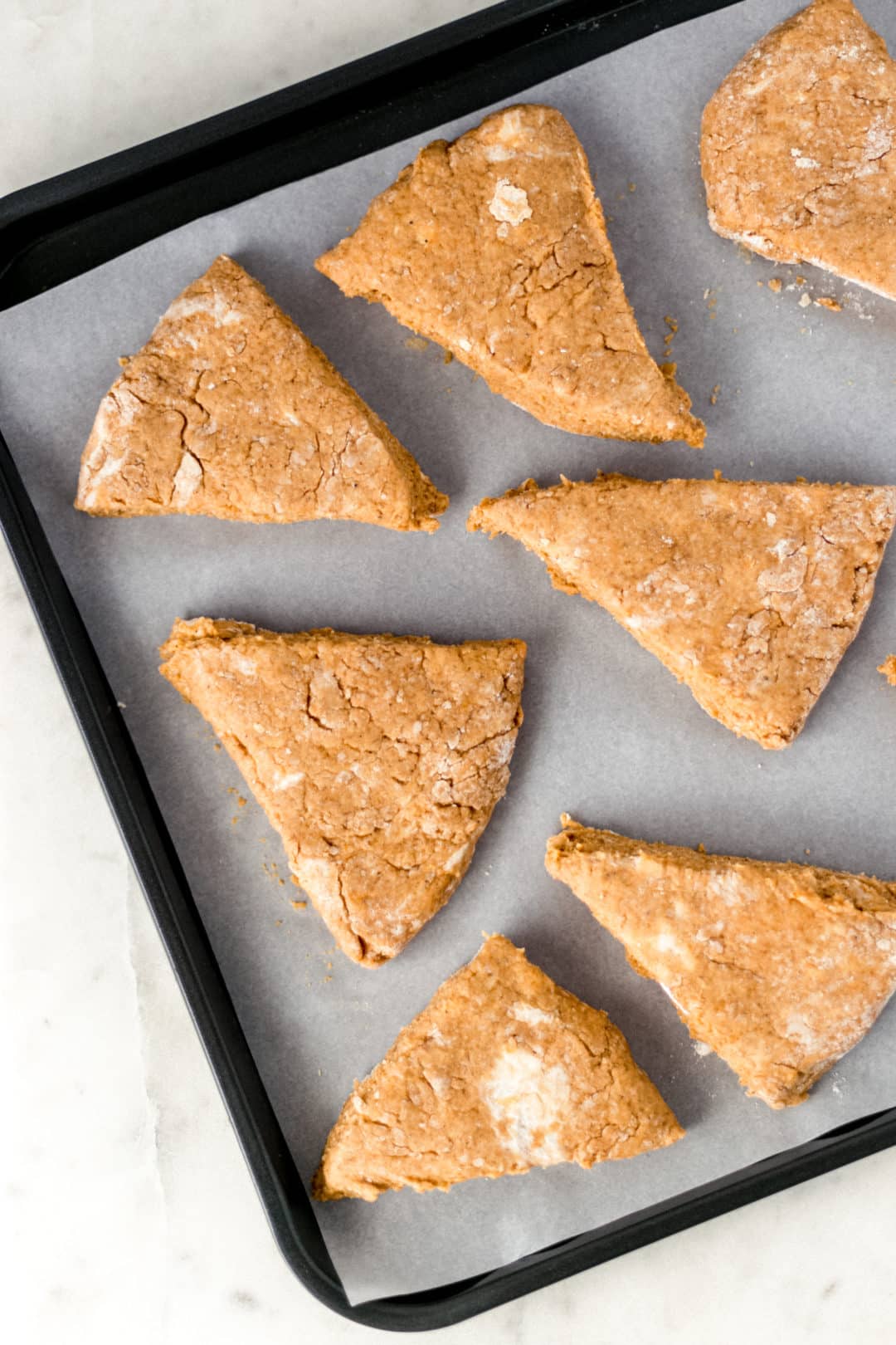 scones on parchment lined baking sheet before baking 