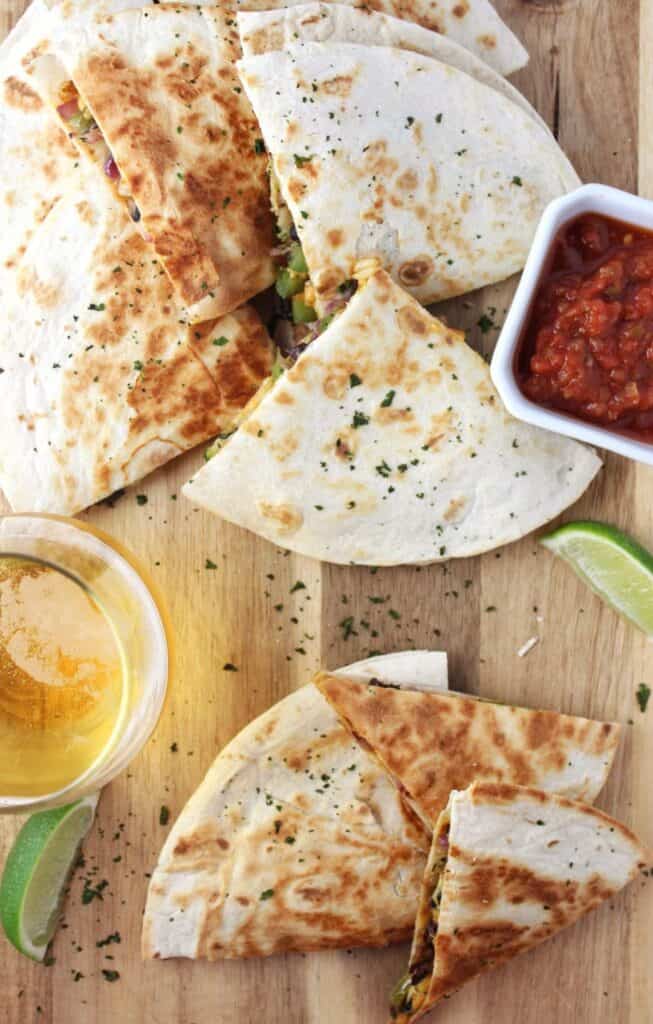 Easy Vegan Quesadillas - A meal in 30 minutes or less is what you get with these veggie loaded quesadillas that include vegan cheddar shreds. simplylakita.com #vegan #easyrecipe