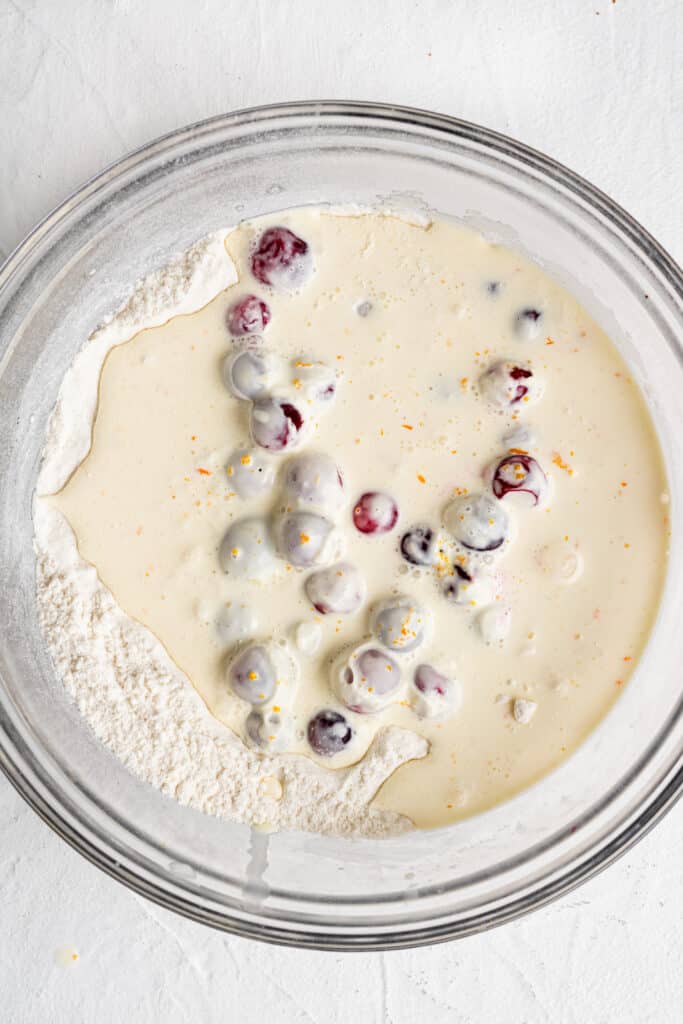 wet and dry mixture to make scones combined together in glass mixing bowl 