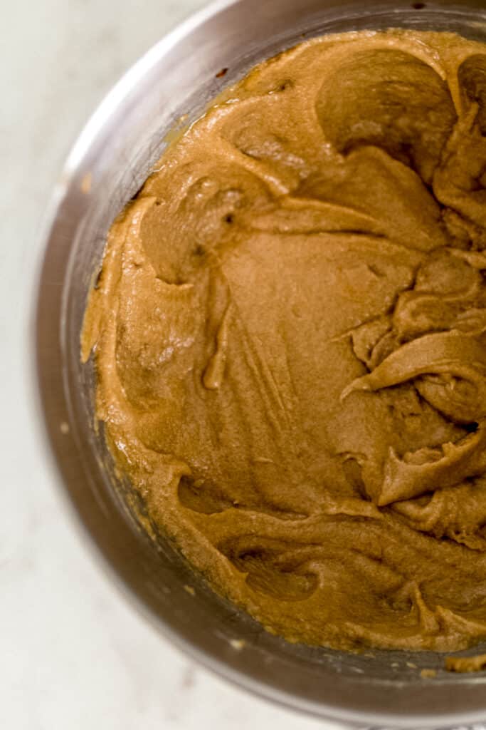 stand mixer bowl with ingredients for cookies combined together