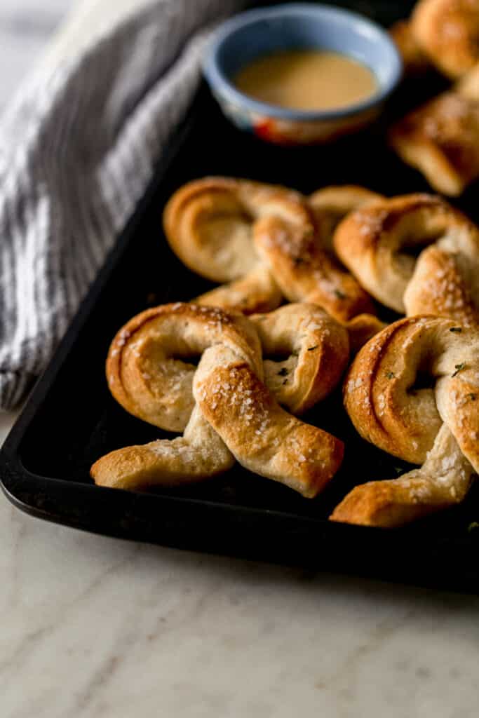 close up side view soft pretzels on a sheet pan