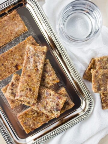 finished bars on silver platter on top of linen cloth beside glass of water